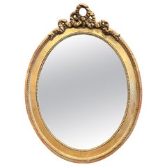 19th Century French Carved Giltwood Oval Wall Mirror with Louis XVI Ribbon Bow