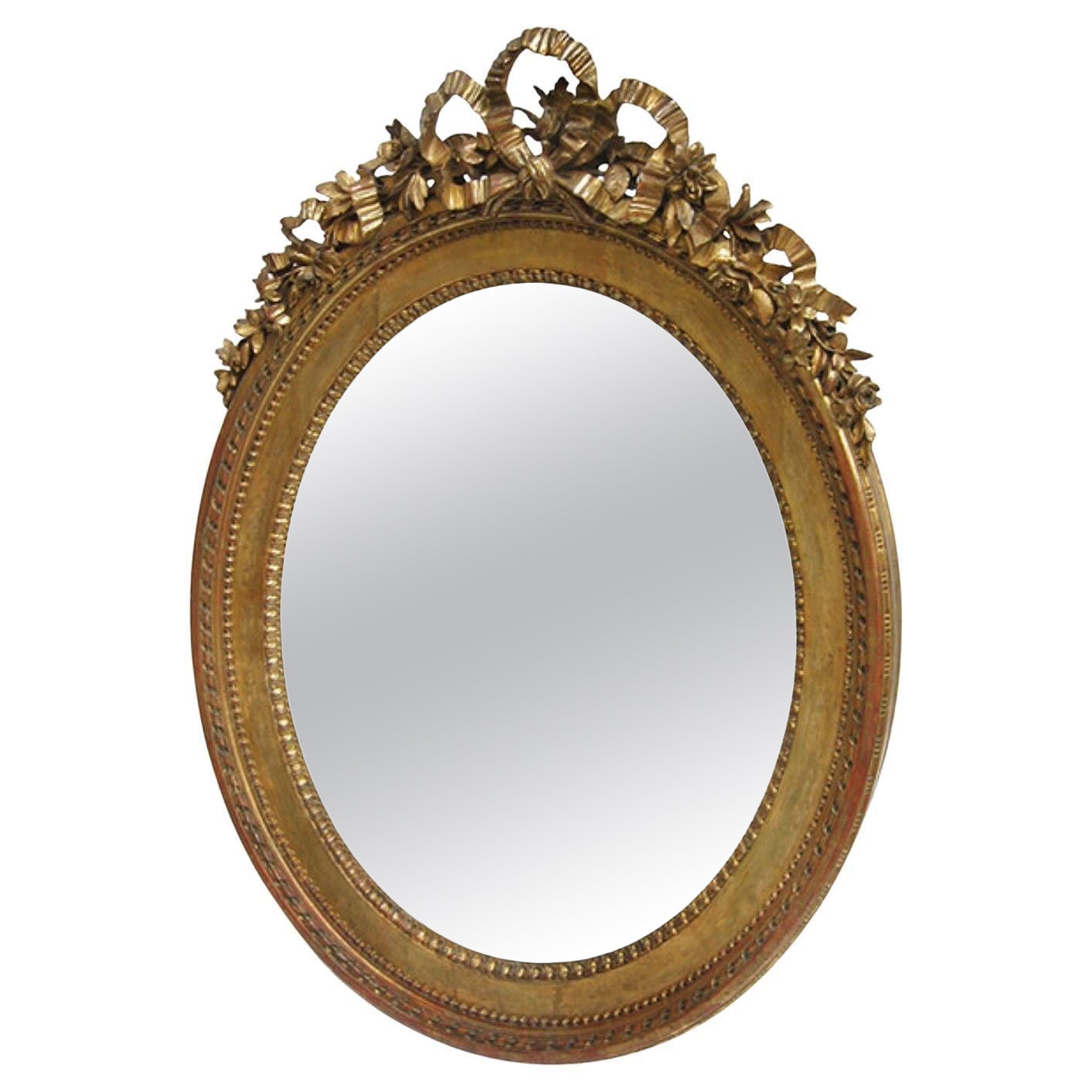 Miroir ovale Louis XVI en bois doré