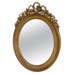 Miroir ovale Louis XVI en bois doré