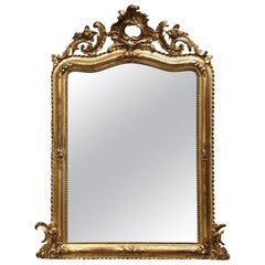 Miroir rocaille Louis XV du 19ème siècle en bois doré sculpté et arqué