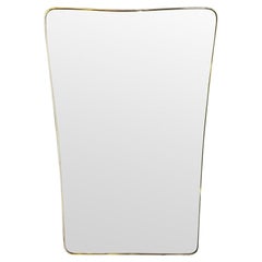 A large original Italian 1950s brass framed mirror with original bevelled plate
