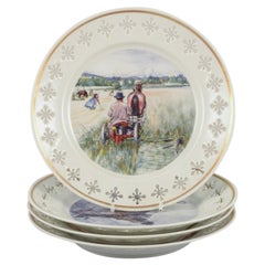 Bing & Grøndahl. Four porcelain plates with motifs from Carl Larssons paintings.