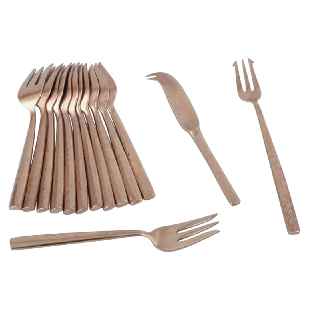 Scandinavian designer. Twelve-person cheese service in hammered brass