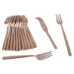 Scandinavian designer. Twelve-person cheese service in hammered brass