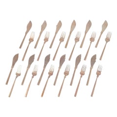 Scandinavian designer. Complete twelve-person fish service in hammered brass.
