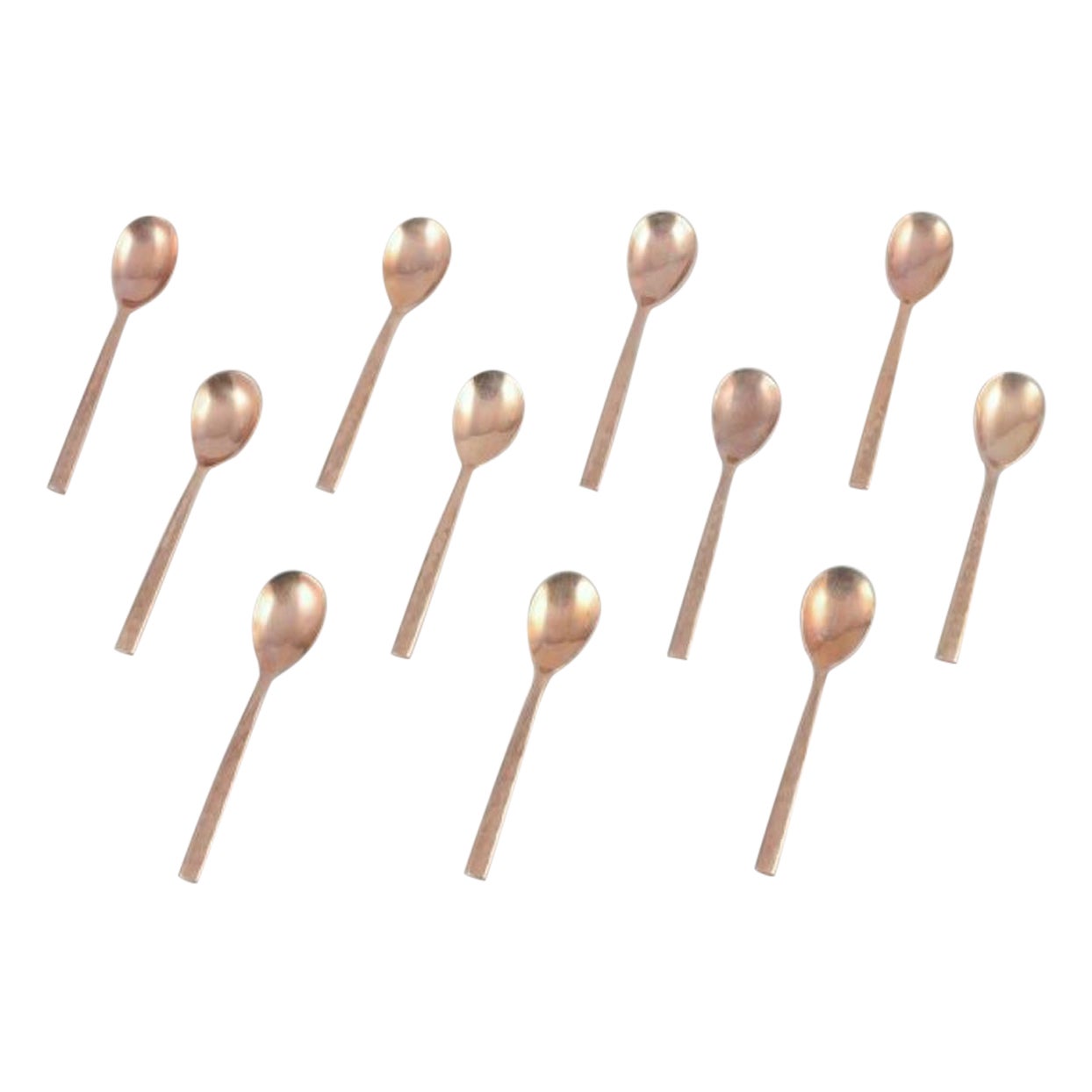 Scandinavian designer. Set of eleven coffee spoons in hammered brass.