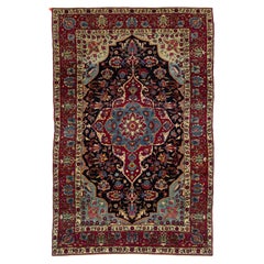 Antico tappeto persiano Kerman in lana blu scuro con disegno floreale a medaglione