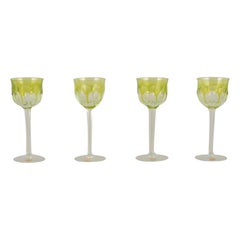 Moser, Czech Republic. Four tall white wine glasses in clear and green glass