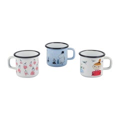 Muurla, Finland. Three enamel mugs with illustrations of Moomins