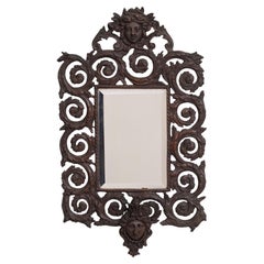 Miroir mural ancien en bronze moulé à tête de femme