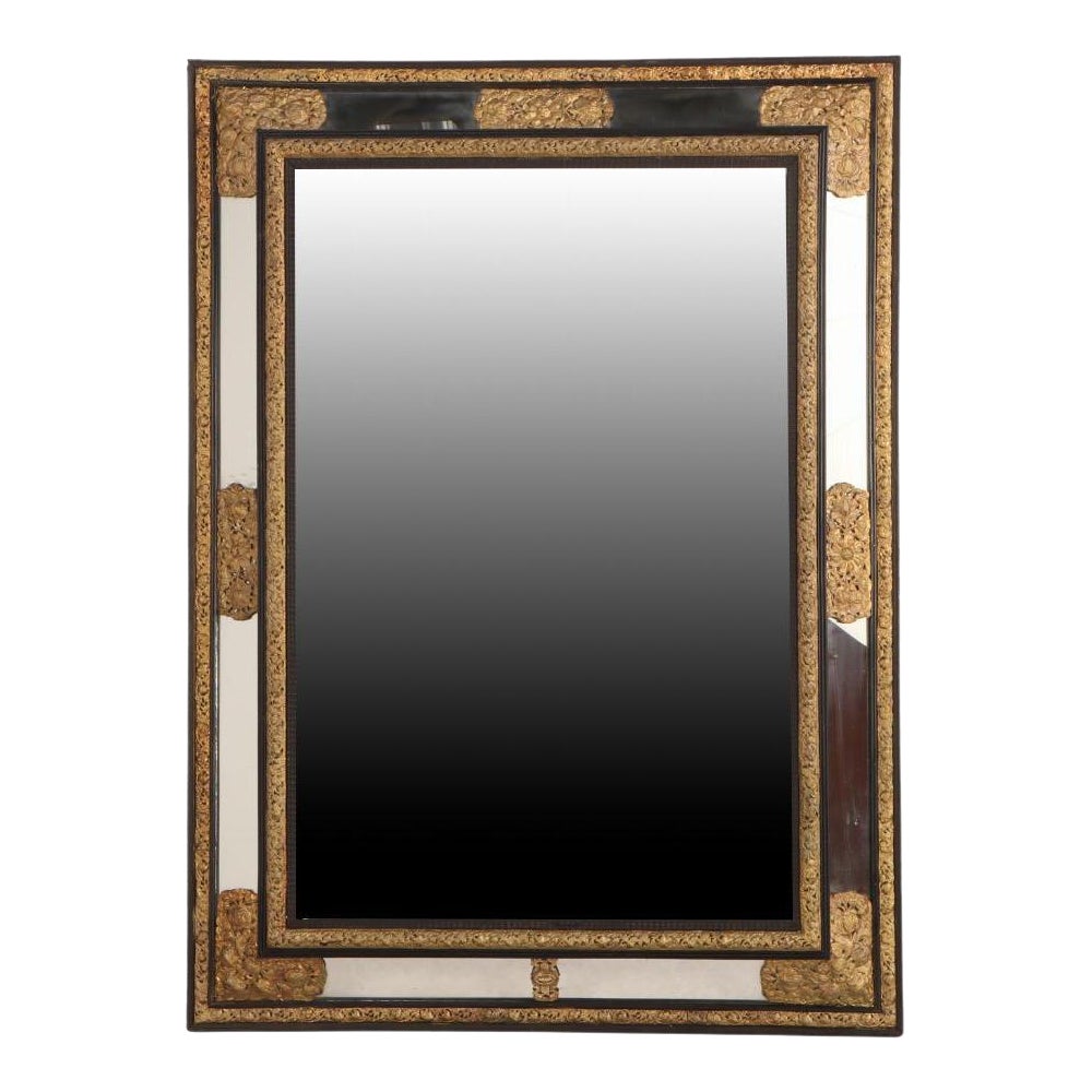 A Rare Large French Ebonized Wood and Brass Repousse Mirror, 19th C.