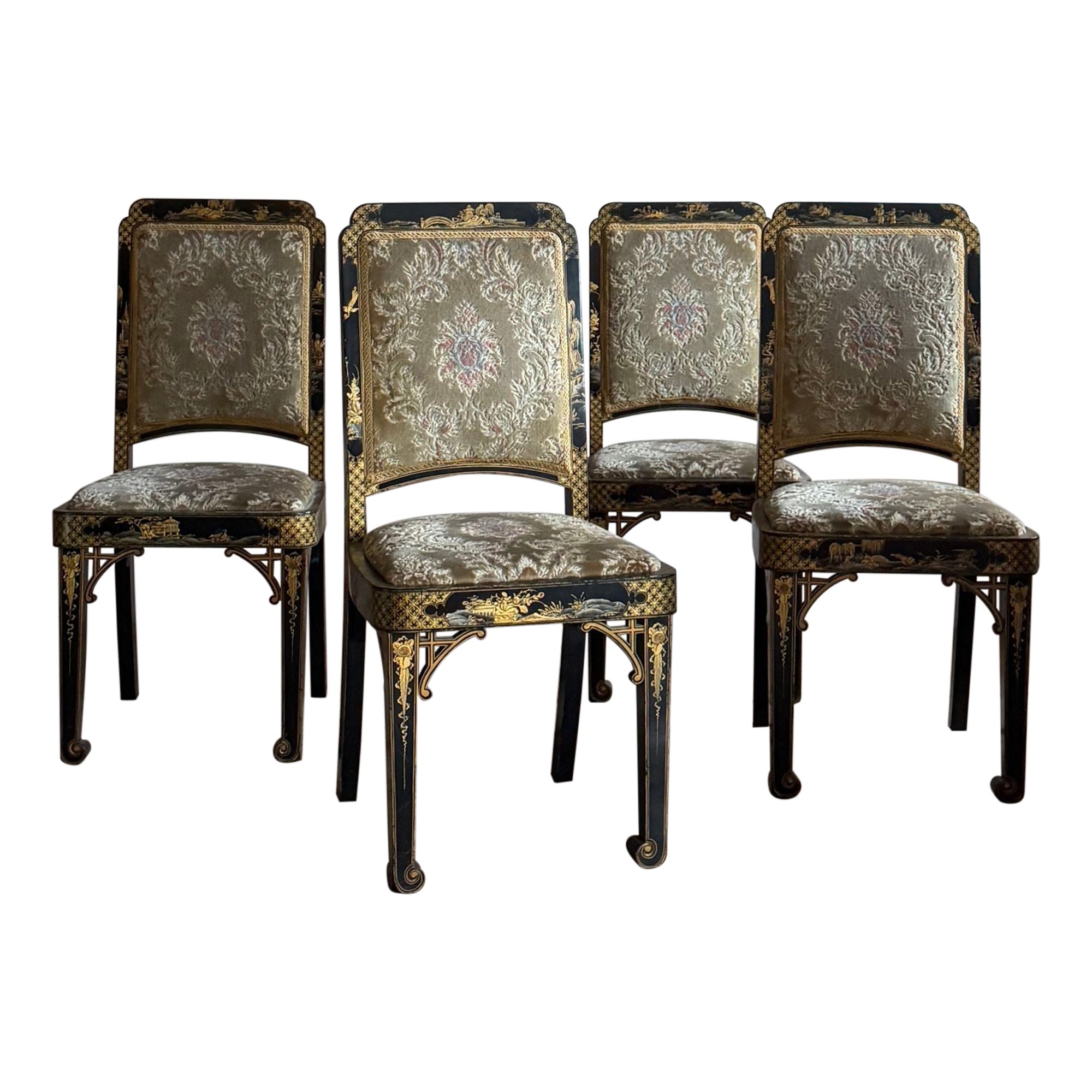 An unusual and glamorous set of four dining chairs with upholstered seats and backs, decorated in black and gold chinoiserie lacquer. Dating from 1921 they come with the original receipt. 
Dimensions; 
H back 99cm
H seat 47cm
W 46cm
D 42cm