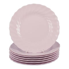 Tuscan, England. Seven plates in light pink porcelain with a wavy edge.