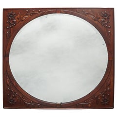 Miroir Continental en acajou sculpté