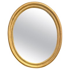 Grand miroir ovale doré des années 1940