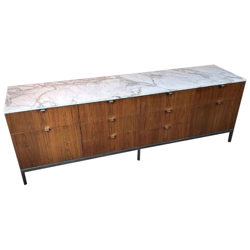 Florence Knoll credenza in rosewood, drawer fronts are book matched with original beautiful Gold Calacatta marble top. The 10 drawer Rosewood cabinet has been restored, chrome pulls and base polish, showing only light patina. Calacatta top is free