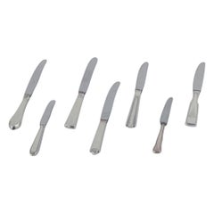 Seven fruit knives in sterling silver with stainless steel blades.