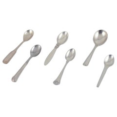 Vintage Georg Jensen, Cohr, and others. Five coffee spoons and a marmalade spoon.