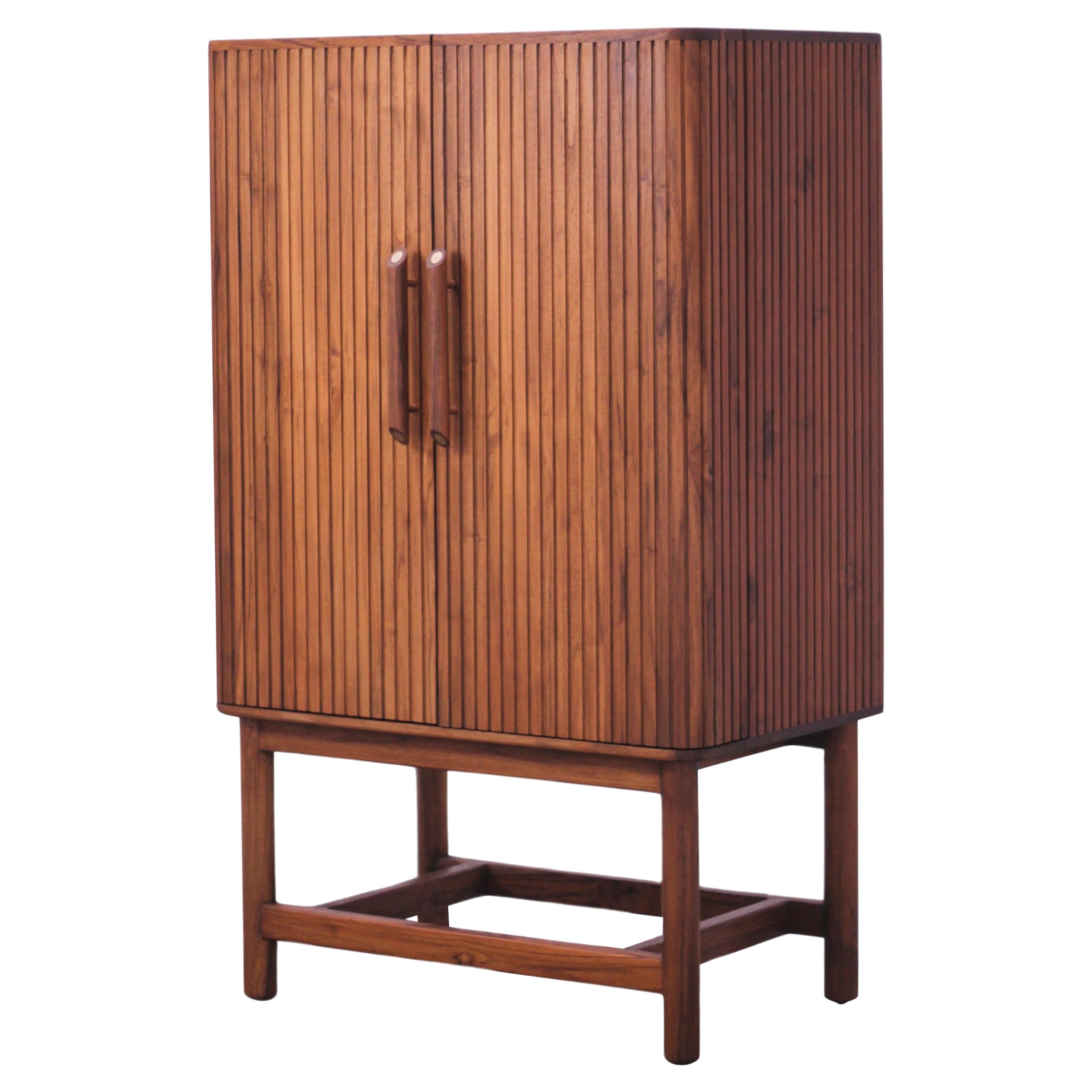 Suave is a hide-a-bar cabinet handcrafted entirely in American Oak wood with brass inlay and details. You can use it as a standalone piece of furniture for everyday living. But when it's time to celebrate, simply open the doors and unleash its