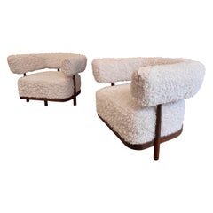 A fabulous pair of Italian curved walnut armchairs in lambswool fur