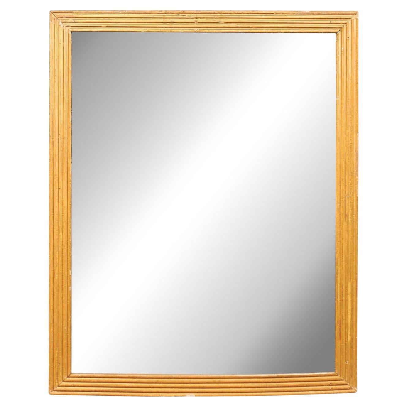 Miroir français du 19ème siècle avec contour linéaire sculpté en flûte et verre d'origine en vente