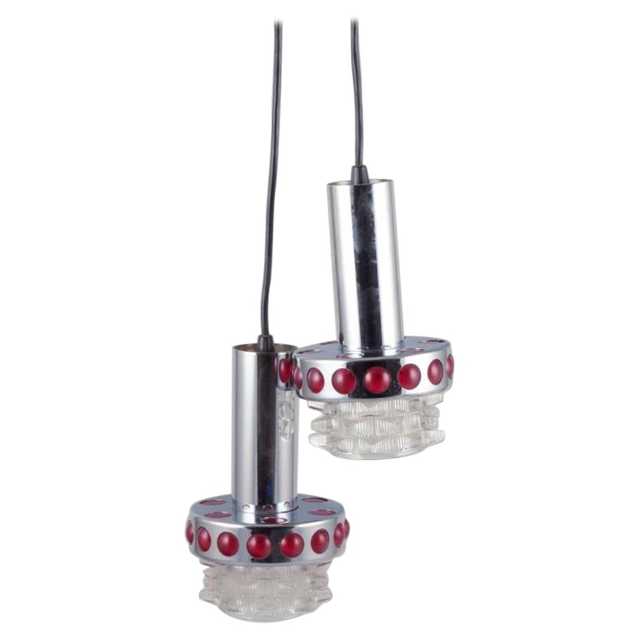 Raak, Holland. Two ceiling pendants in chromed metal and art glass. 1970s.