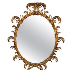 Mid-Century Italian Hollywood Regency Carved Giltwood Oval Mirror