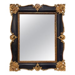 Wall mirror in black lacquered wood and carved with golden shells, Italy
