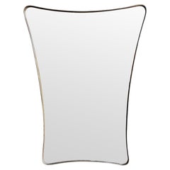 A large 1950s orignal Italian shield mirror with solid brass frame.