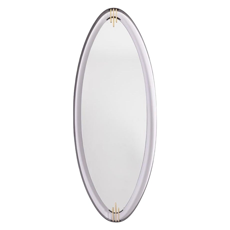 Specchio in ottone laccato e patinato, di forma ovoidale. Anni '50/'60. in vendita
