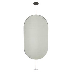 Capsula Miroir en forme de pilule fixé du comptoir au plafond, cadre en patine bronze
