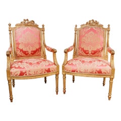 A fine pair of 19th century French Louis XVI gilt carved armchairs