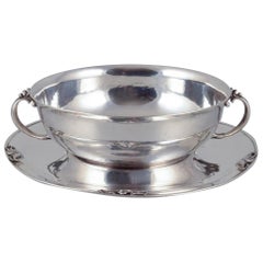 Harald Nielsen for Georg Jensen. Sterling silver bowl with handles on a saucer.