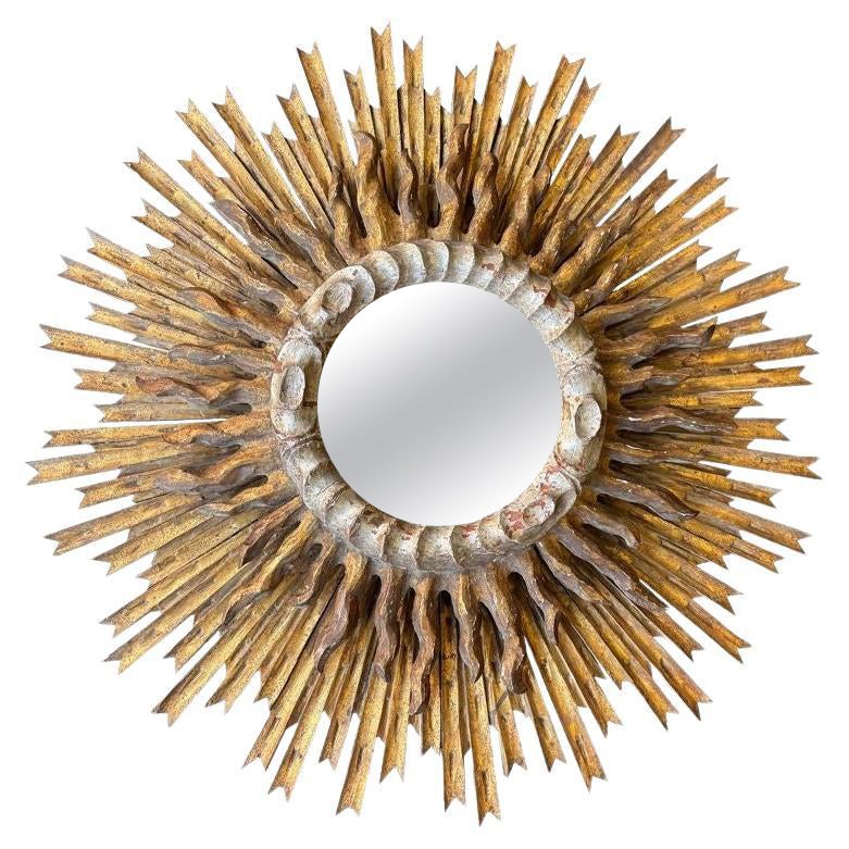 A large 1940s French carved wood gilt sunburst mirror