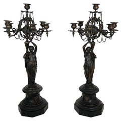 Pair of Important Candelabra in Patinated Bronze Presenting Caryatids Carrying