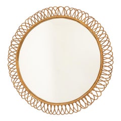 Round rattan mirror with interlacing. 1980s.