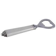 Pirámide Georg Jensen. Abrebotellas de plata de ley y acero inoxidable.