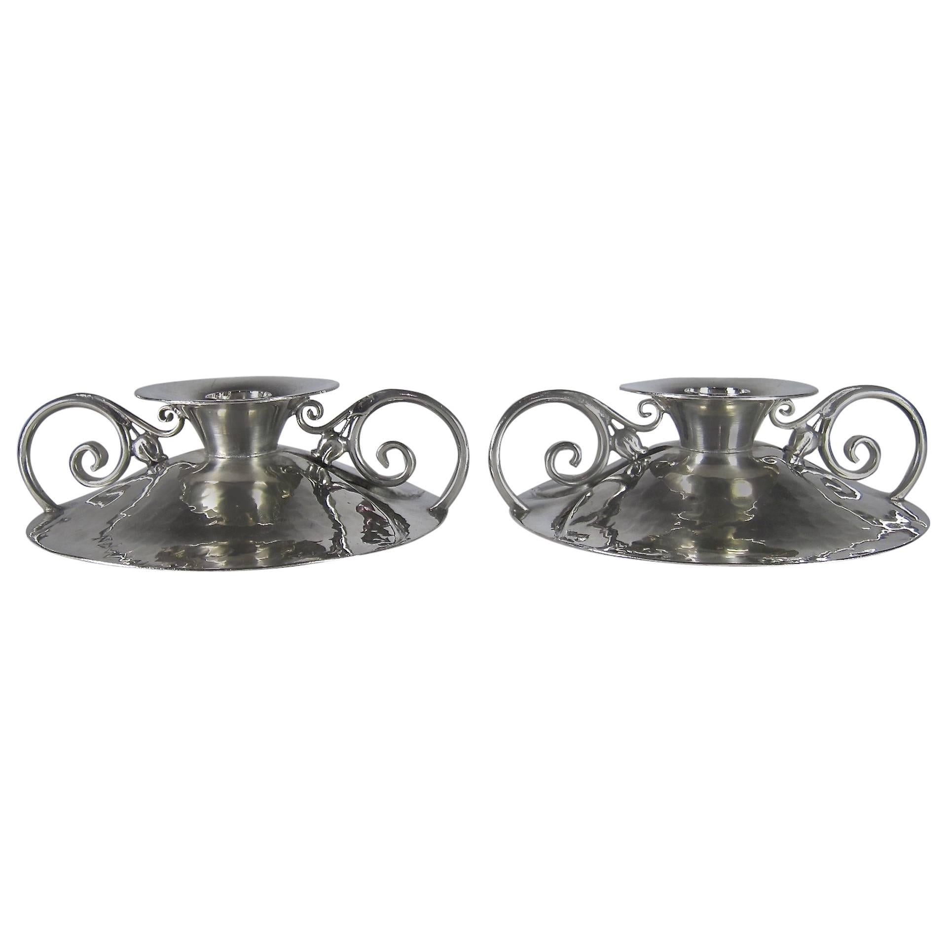 A pair of American Arts and Crafts candle holders that become tazza dishes when reversed, hand-hammered in highly polished pewter by Serge Nekrassoff (1895-1985) of Darien, Connecticut, in the 1930s.

The design is reminiscent of Nekrassoff's