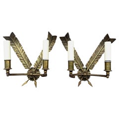 A pair of 1920s brass wall sconces in the empire style with feather design