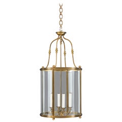 A Large Cylindrical Brass Hall Lantern With Curved Glass