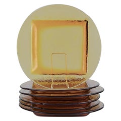 Scandinavian glass designer. Set of six dinner plates in smoke-coloured glass