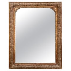 Miroir en bois doré patiné avec cadre sculpté orné, 19e siècle