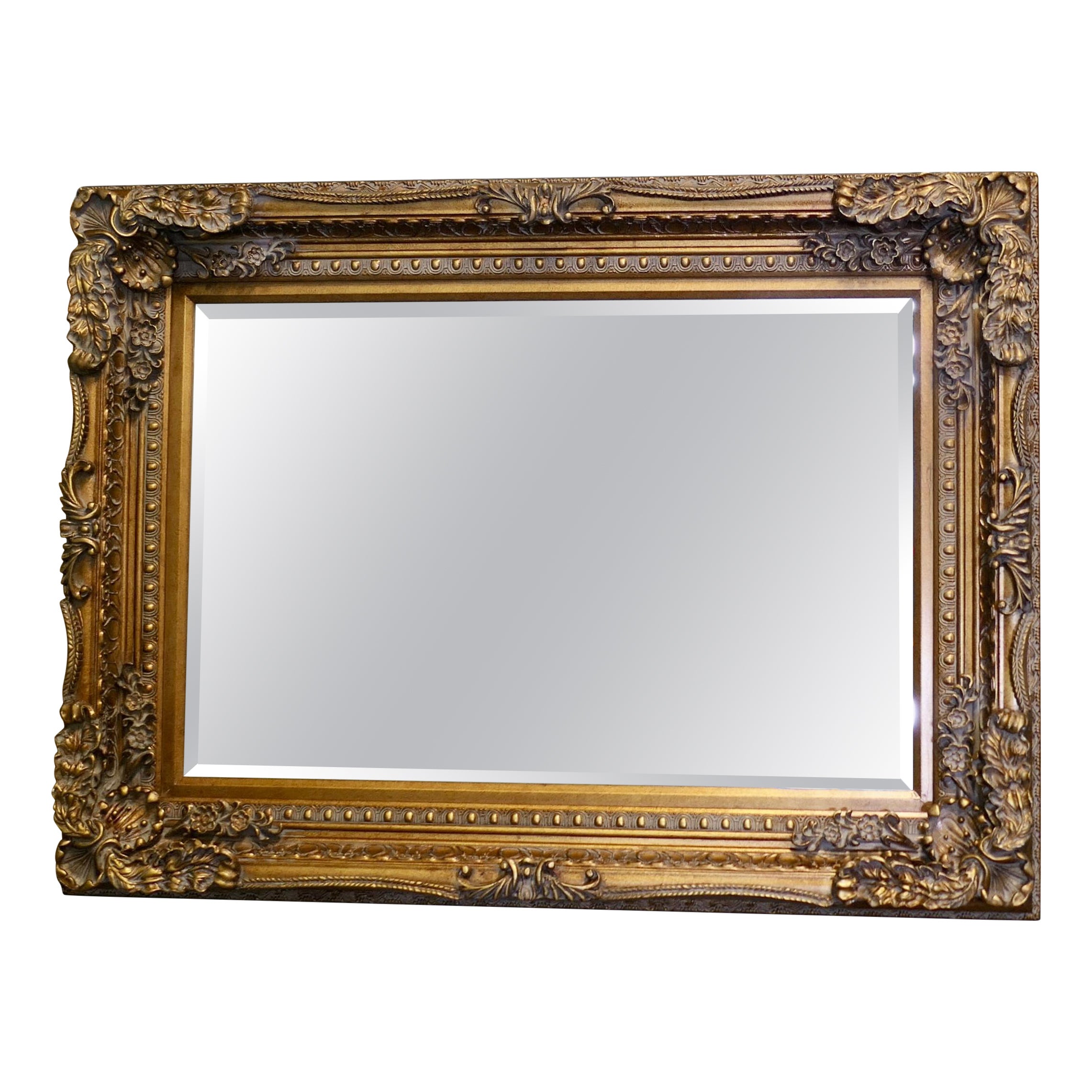 Large Decorative Gilt Wall Mirror  This is a lovely old bevelled mirror