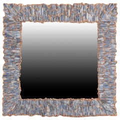 A Blue Kianyte and gilt resin wall mirror.