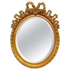 Antique French Gold Oval Mirror with Beveling & Carved Ribbon Design, Circa 1890