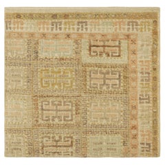 Muestra de alfombra personalizada de Rug & Kilim, con motivos geométricos en beige y verde