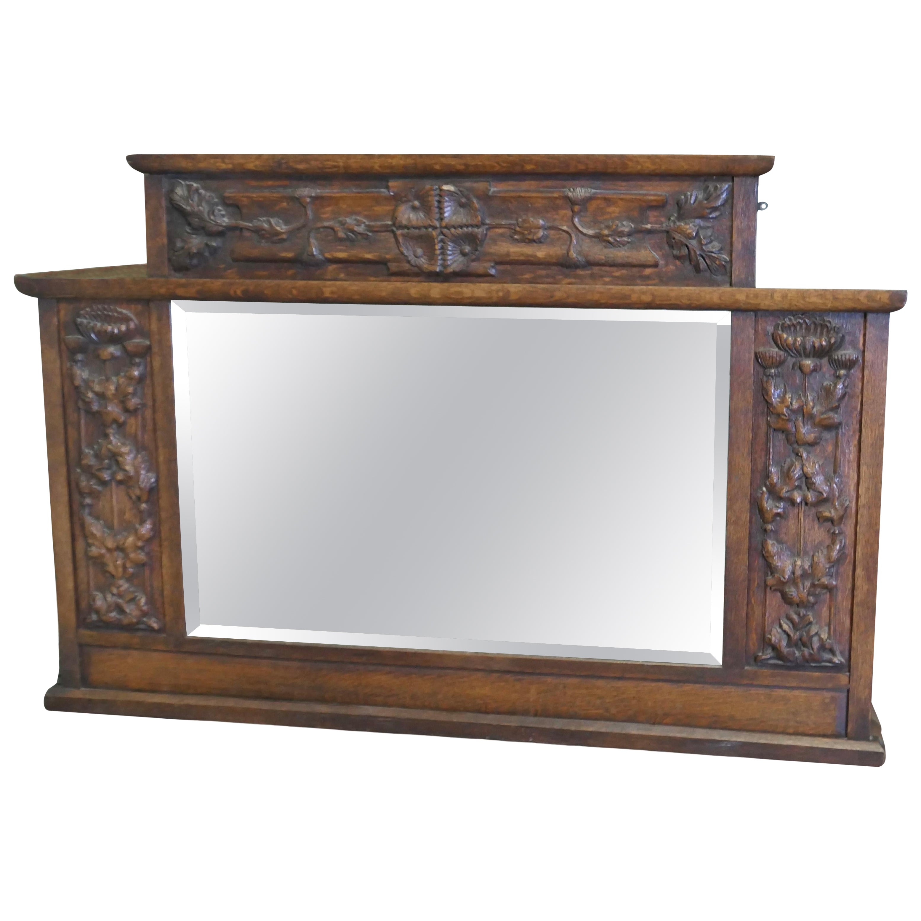 A Large Arts and Crafts Carved Oak Overmantel or Wall Mirror