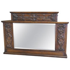A Large Arts and Crafts Carved Oak Overmantel or Wall Mirror