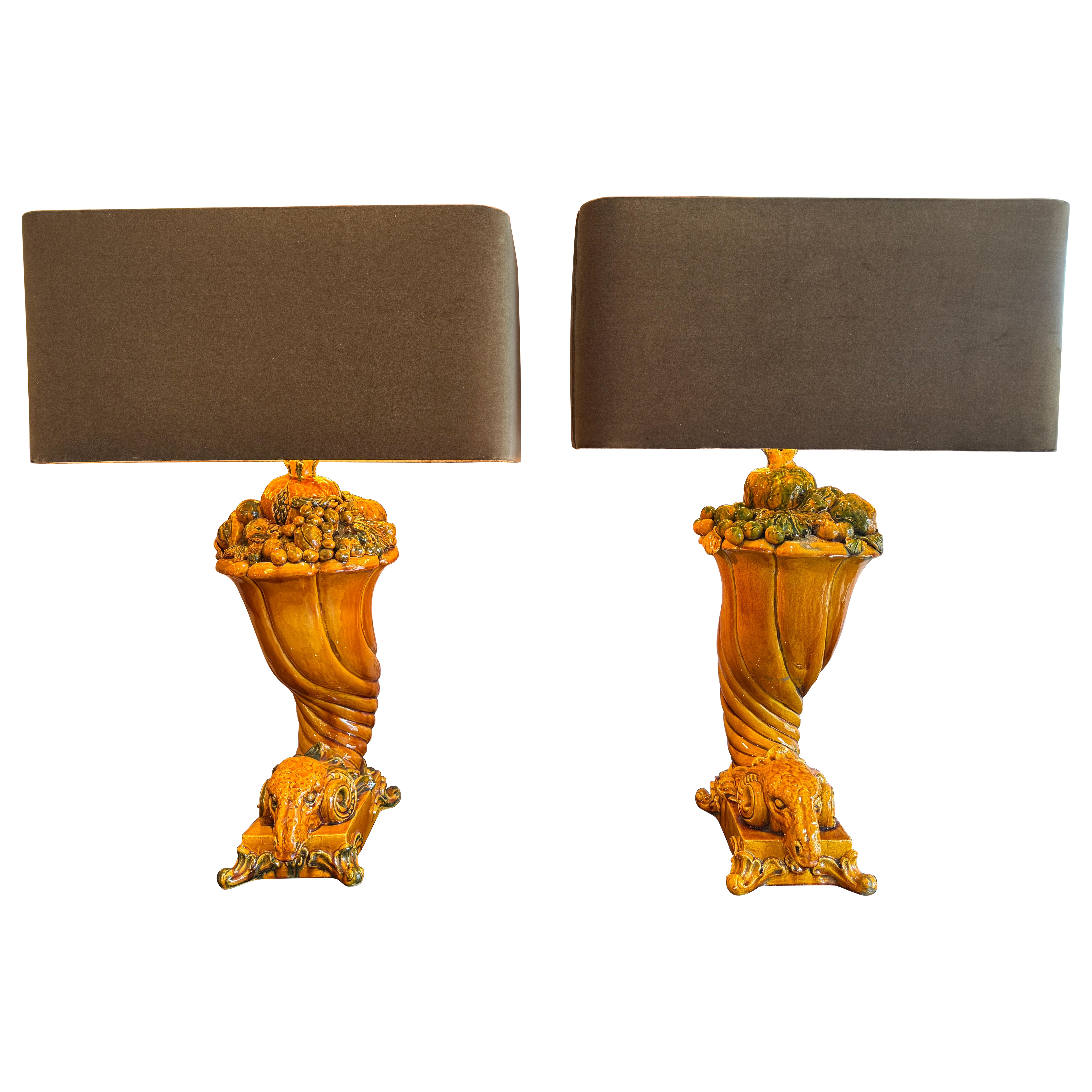 A rare pair of glazed ceramic leaning Rams table lamps .
