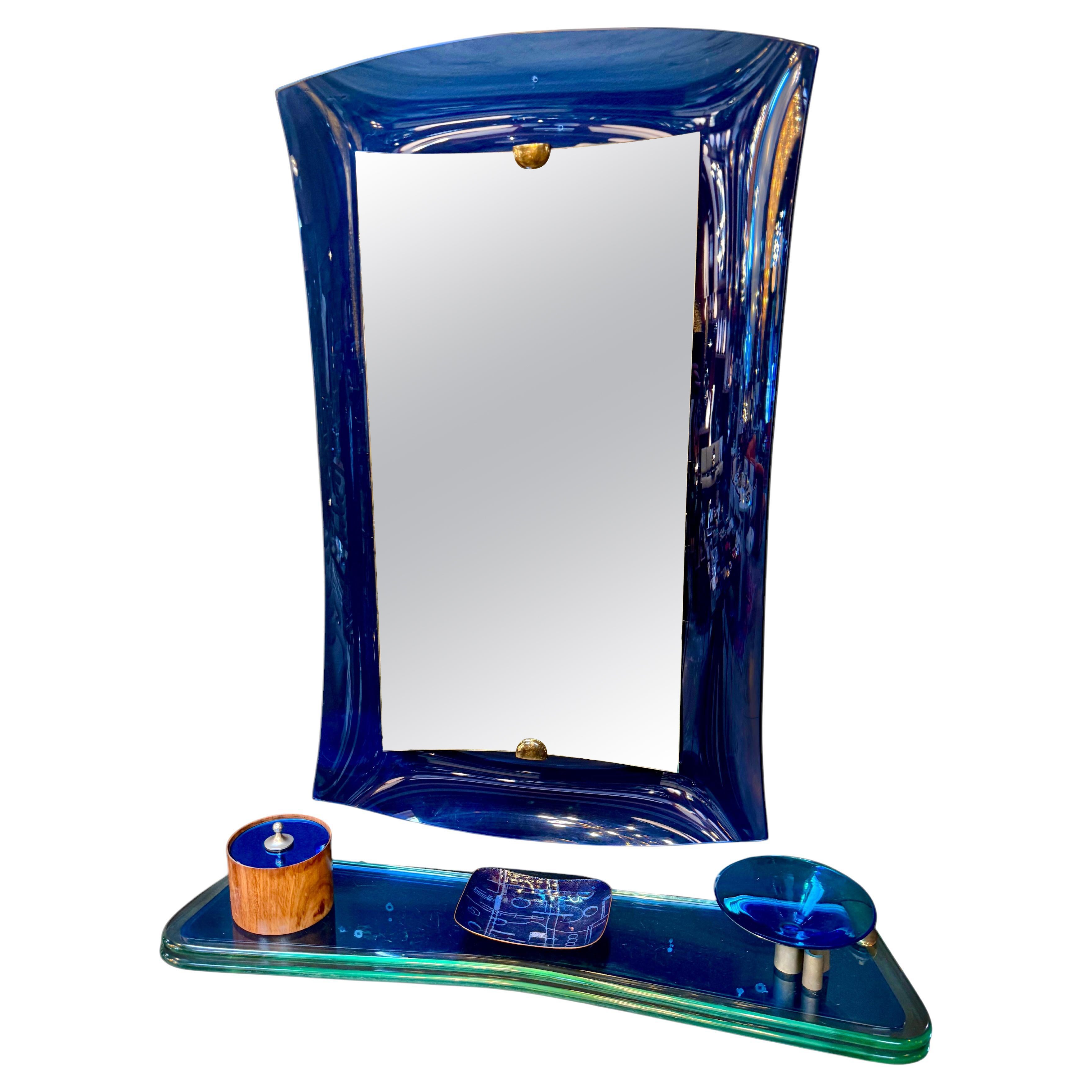 Fontana Arte blue mirror with glass console. Italy 1970